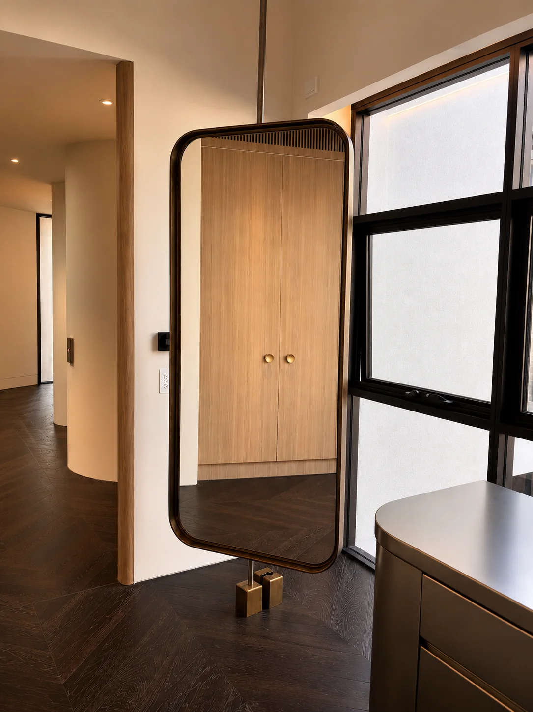 Custom metal cabinet with glass doors in a modern interior