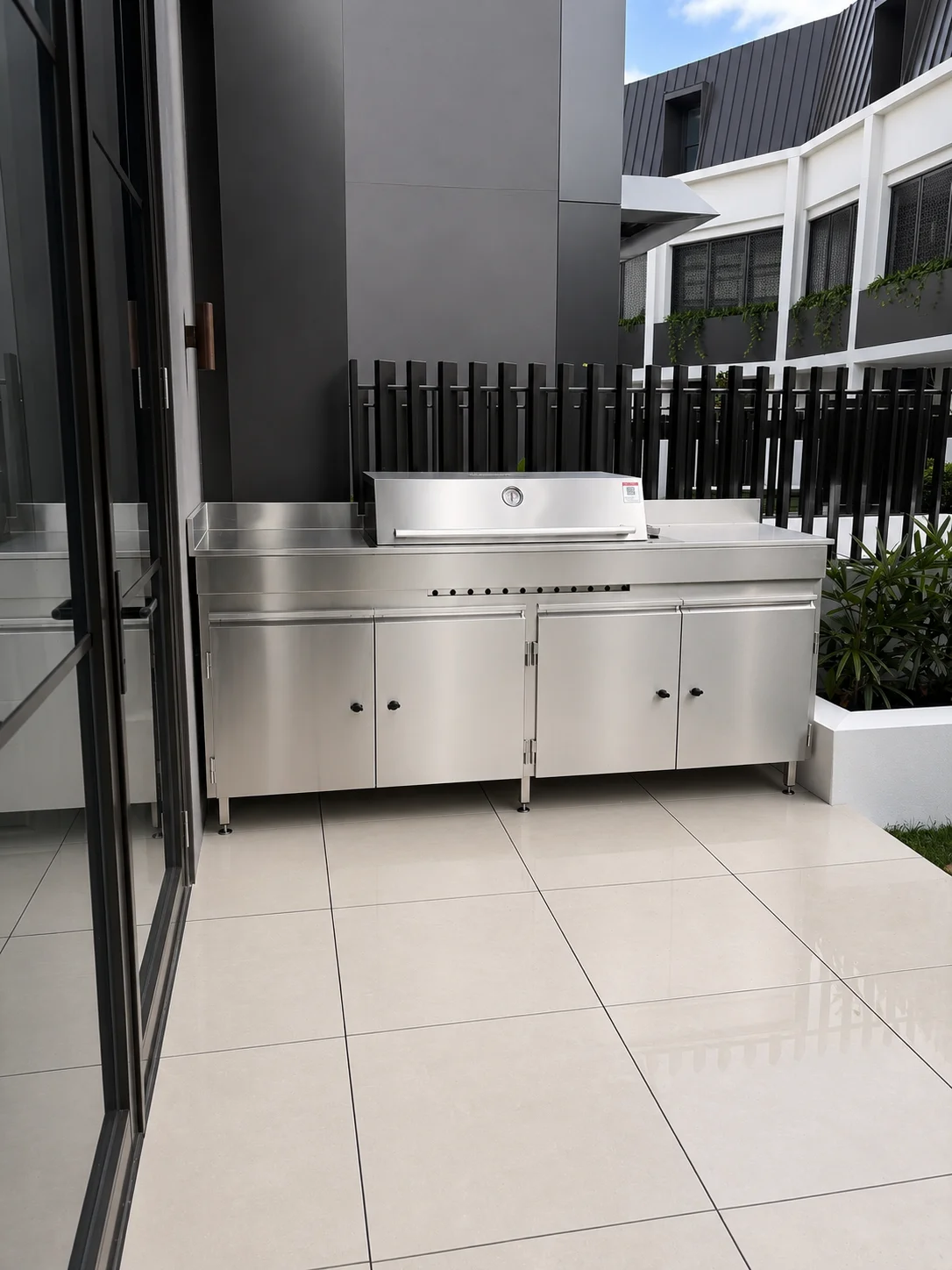 Stainless steel BBQ cabinet in a covered patio area