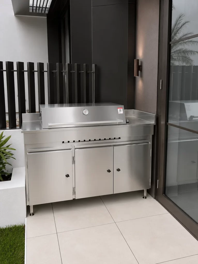 Stainless steel BBQ and storage unit against a black wall