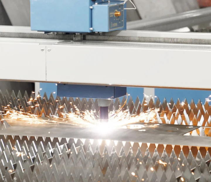 Laser cutter cutting sheet metal with sparks